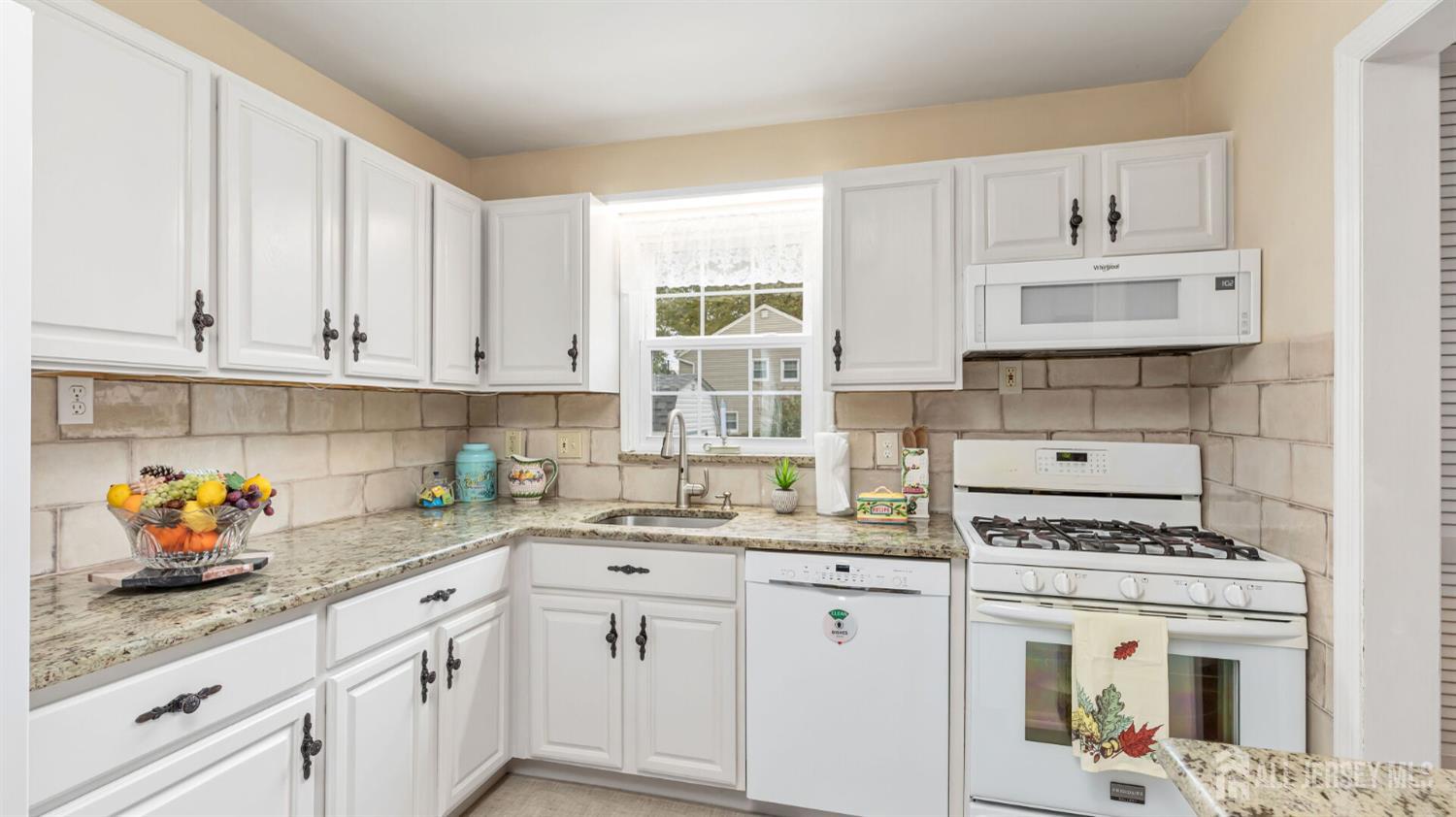 77-89 Parkside Road Plainfield, NJ 07060 - Photo 12 of 42 a kitchen with stainless steel appliances white cabinets and a stove top oven