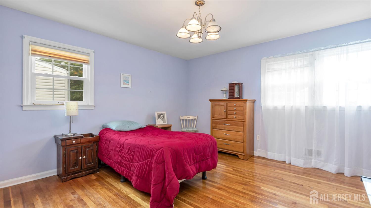 77-89 Parkside Road Plainfield, NJ 07060 - Photo 18 of 42 a view of a bedroom with a bed and wooden floor