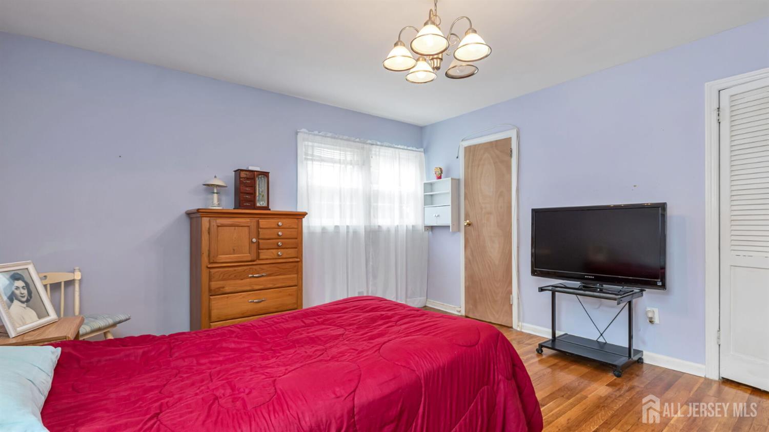 77-89 Parkside Road Plainfield, NJ 07060 - Photo 19 of 42 a bedroom with a bed and a flat screen tv