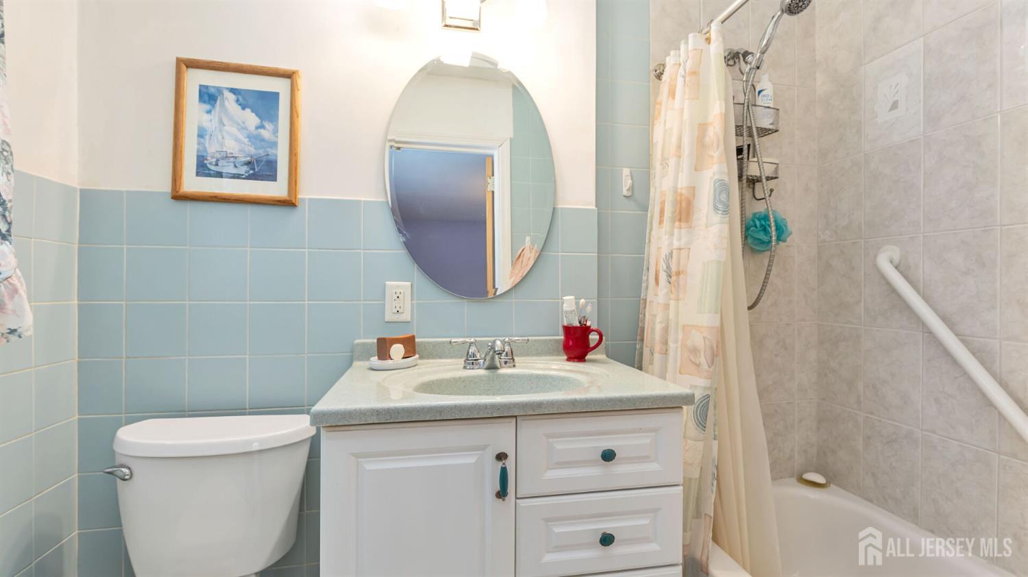 77-89 Parkside Road Plainfield, NJ 07060 - Photo 20 of 42 a bathroom with a sink mirror vanity and toilet