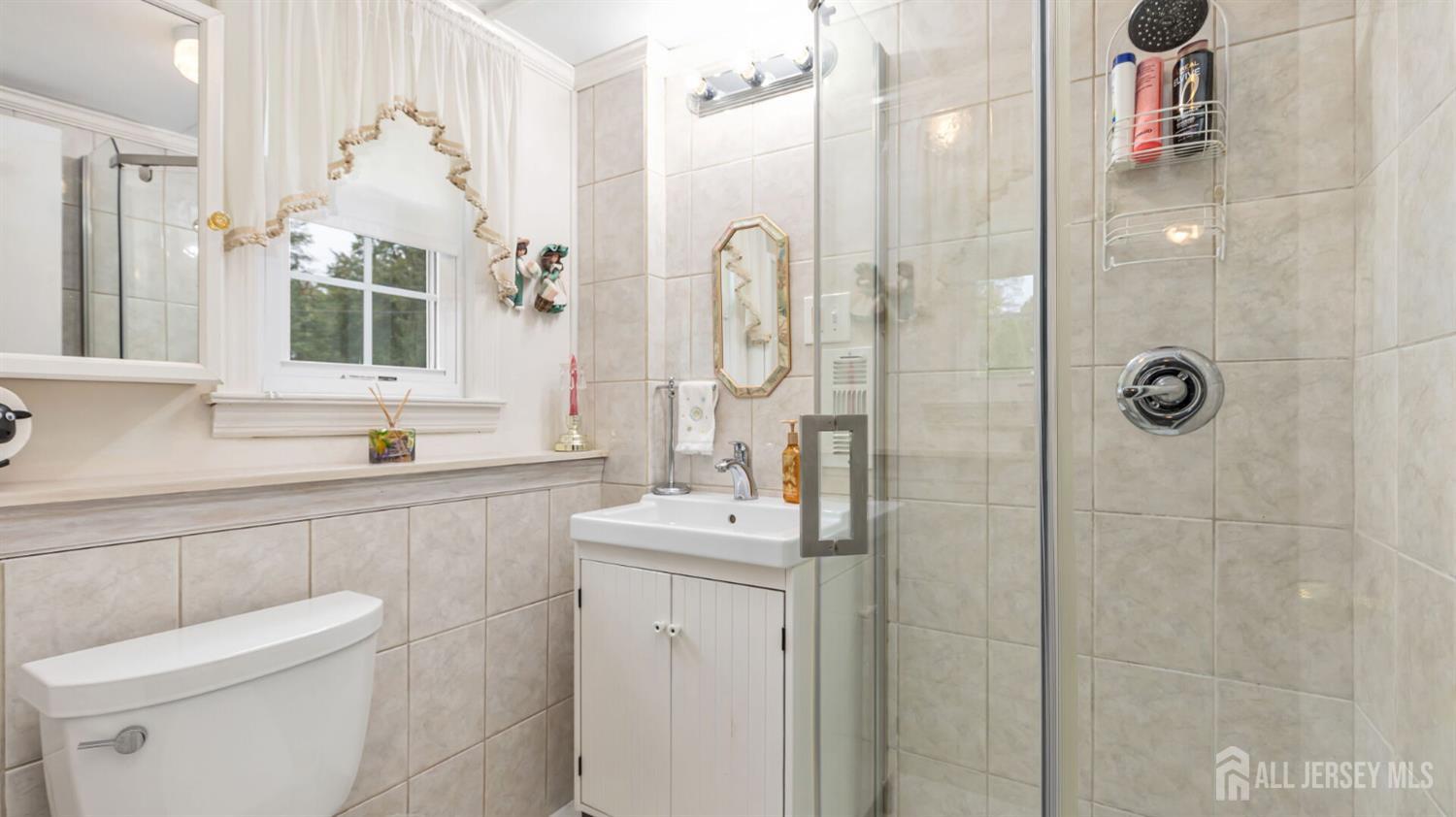 77-89 Parkside Road Plainfield, NJ 07060 - Photo 26 of 42 a bathroom with a sink vanity mirror and toilet