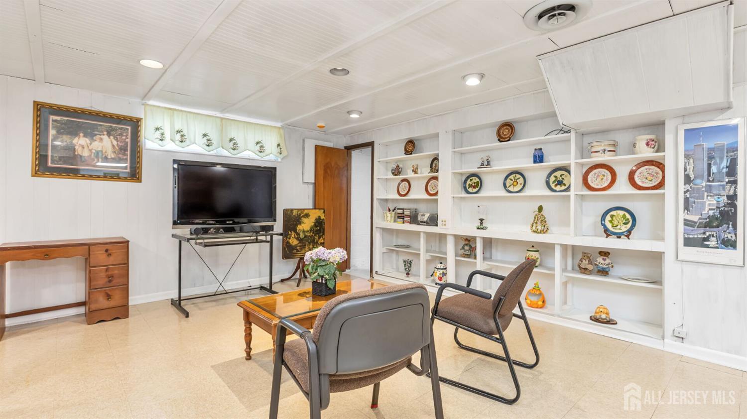 77-89 Parkside Road Plainfield, NJ 07060 - Photo 27 of 42 a living room with furniture and a flat screen tv