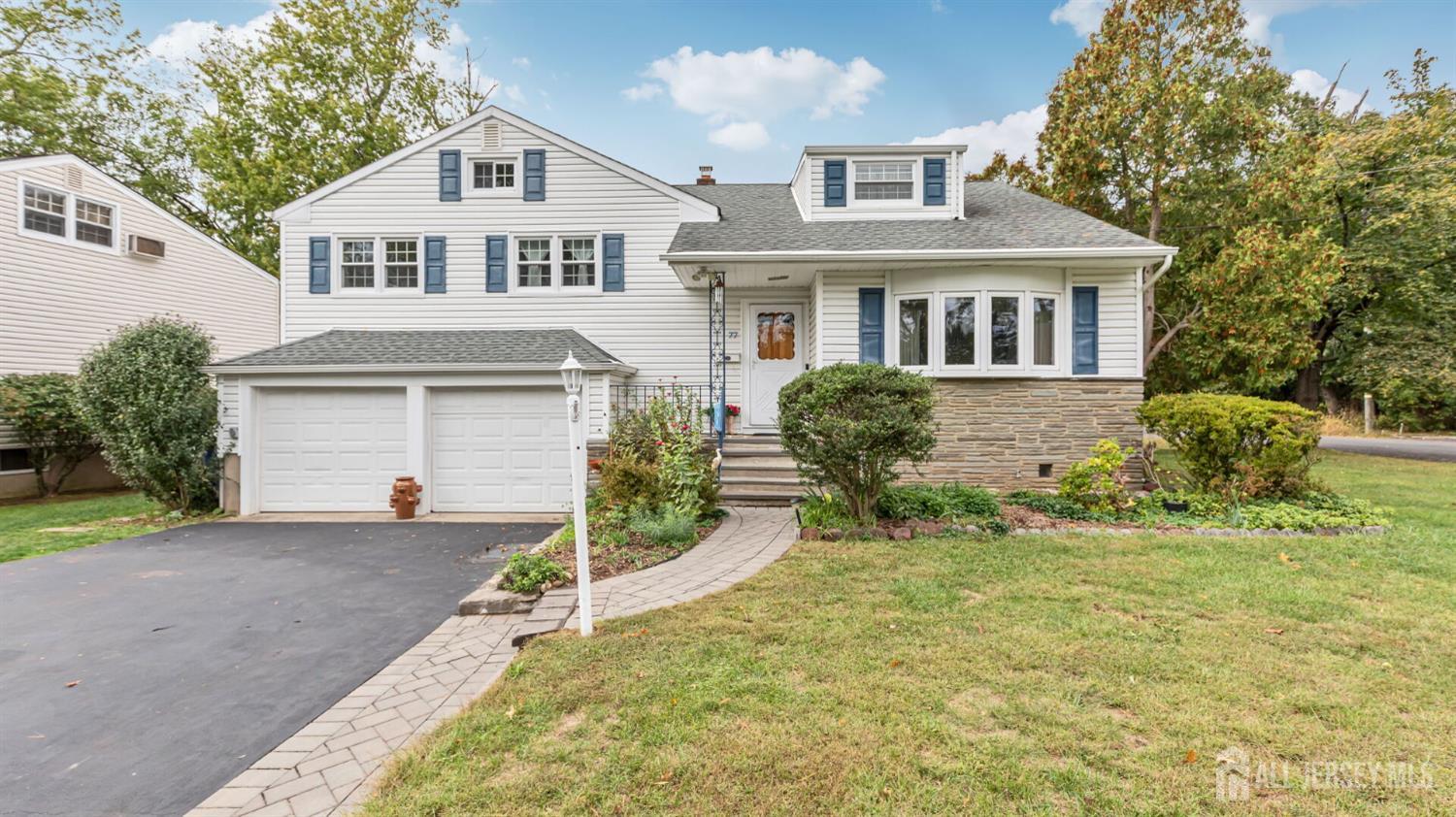 77-89 Parkside Road Plainfield, NJ 07060 - Photo 31 of 42 a front view of a house with a yard and garage