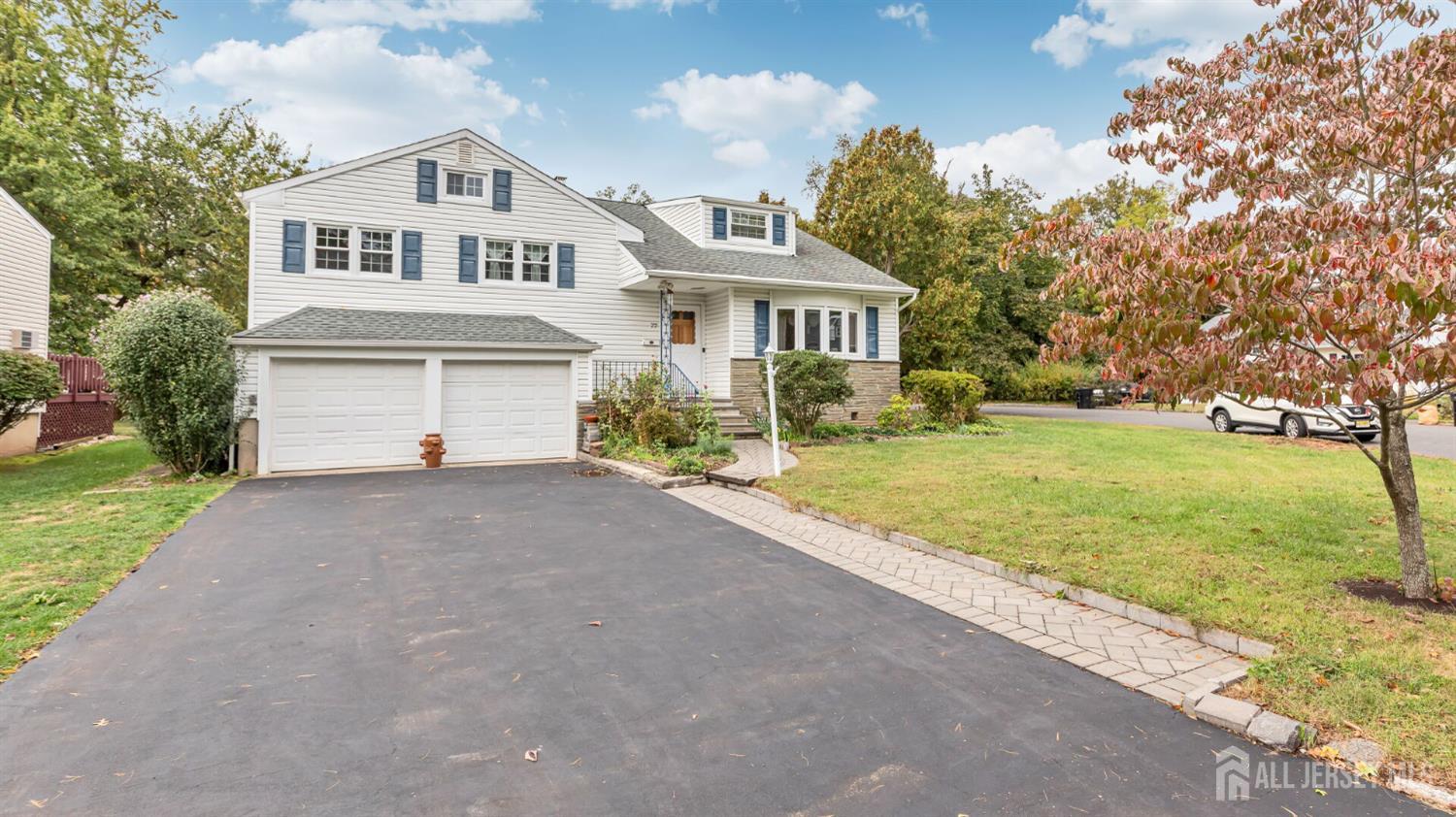 77-89 Parkside Road Plainfield, NJ 07060 - Photo 35 of 42 a front view of a house with a yard and garage