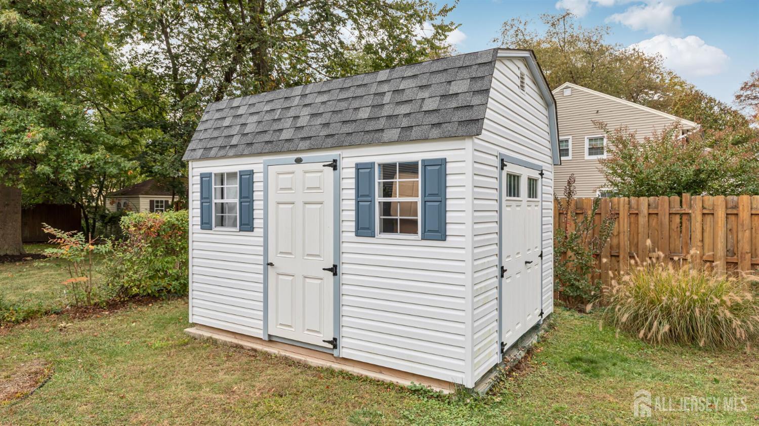 77-89 Parkside Road Plainfield, NJ 07060 - Photo 40 of 42 a view of a white house with a small yard and large tree