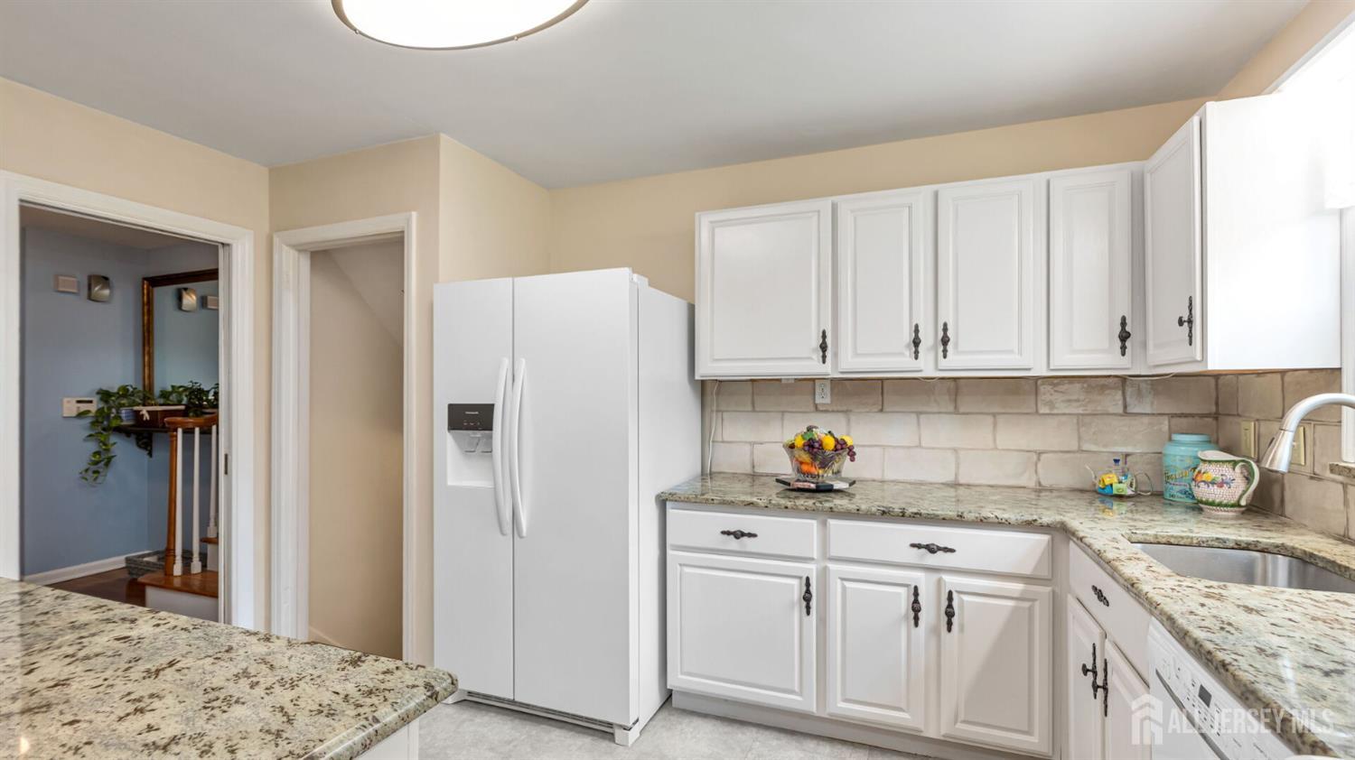 77-89 Parkside Road Plainfield, NJ 07060 - Photo 10 of 42 a kitchen with white cabinets and sink