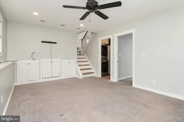 a view of an empty room with a ceiling fan