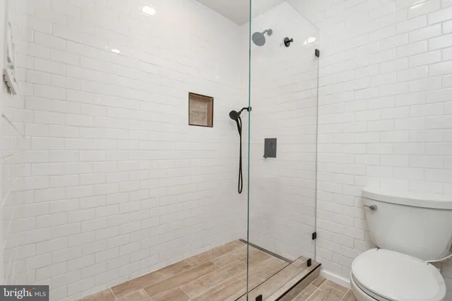 a bathroom with a toilet and a shower