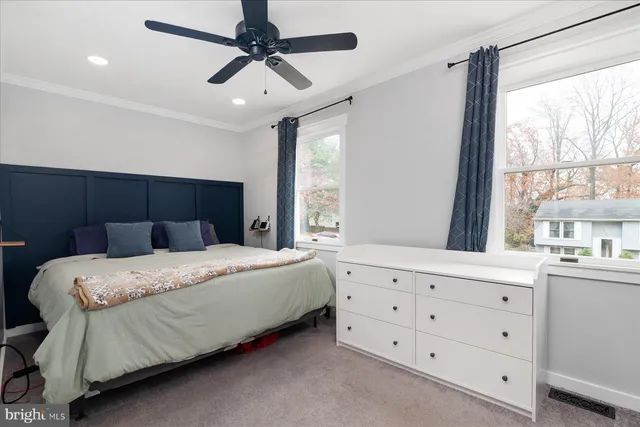 a bedroom with a bed dresser and a window