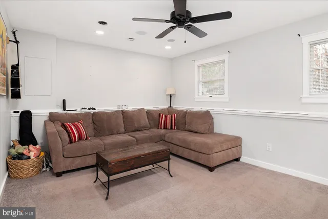 a view of a livingroom with wooden floor and stairs
