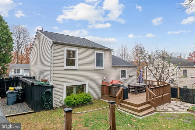 a view of a backyard with a wooden fence