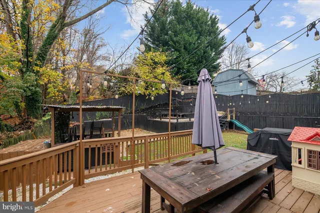 a view of a backyard with couches chair and wooden fence