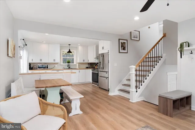 a living room with furniture and kitchen view