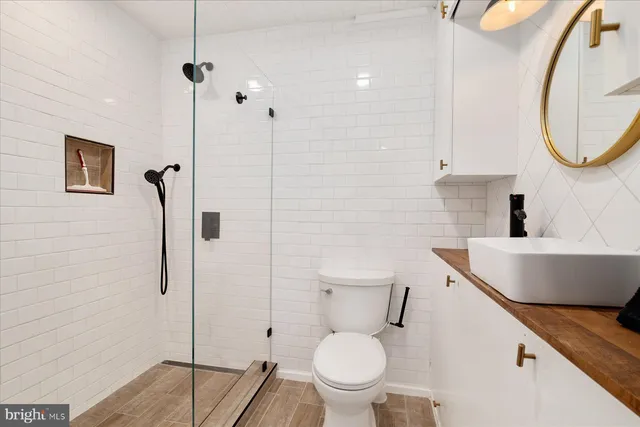 a bathroom with a toilet sink and a mirror