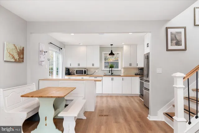 a large kitchen with a table and chairs in it