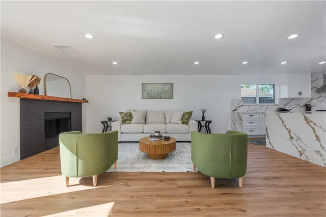 a living room with furniture a fireplace and a table