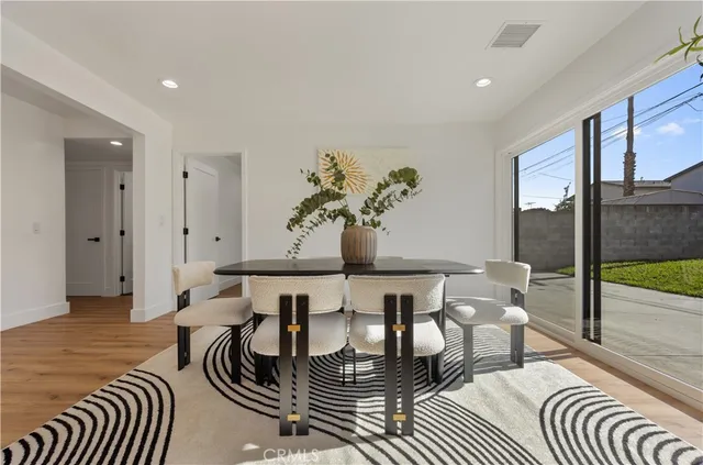 a living room with furniture a potted plant and a fireplace