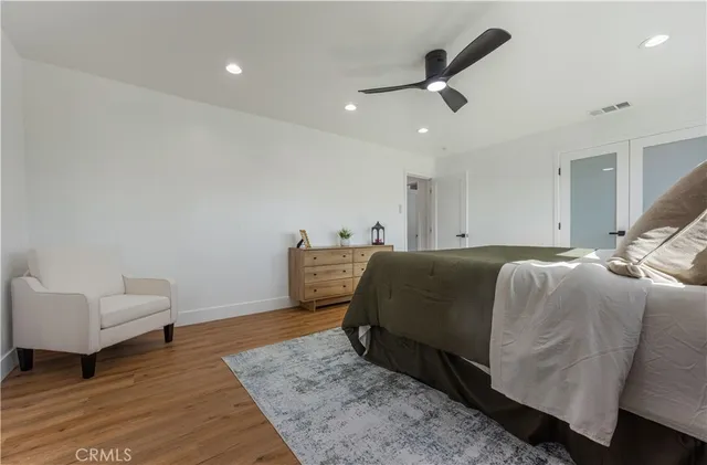 a bed room with a bed and a ceiling fan