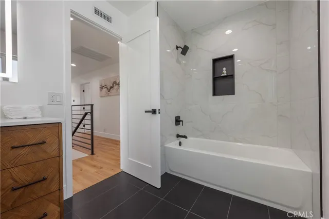 a view of entryway and hall with wooden floor