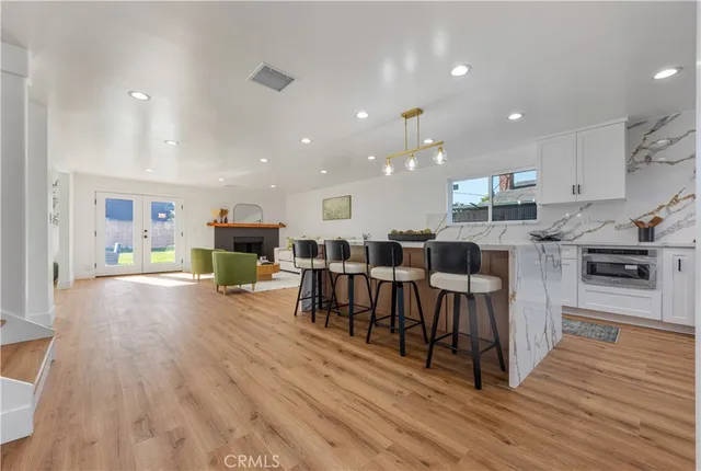 a large kitchen with lots of furniture a sink appliances and a dining table view