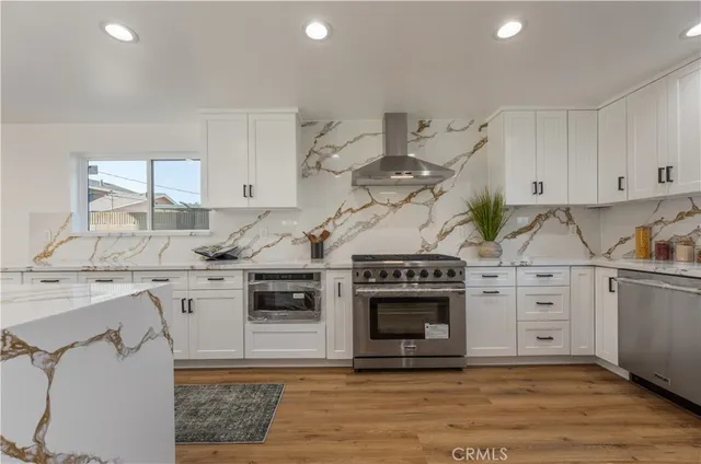 a stove top oven sitting inside of a kitchen