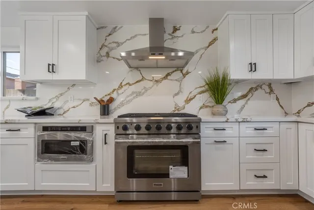 a kitchen with white cabinets and white appliances