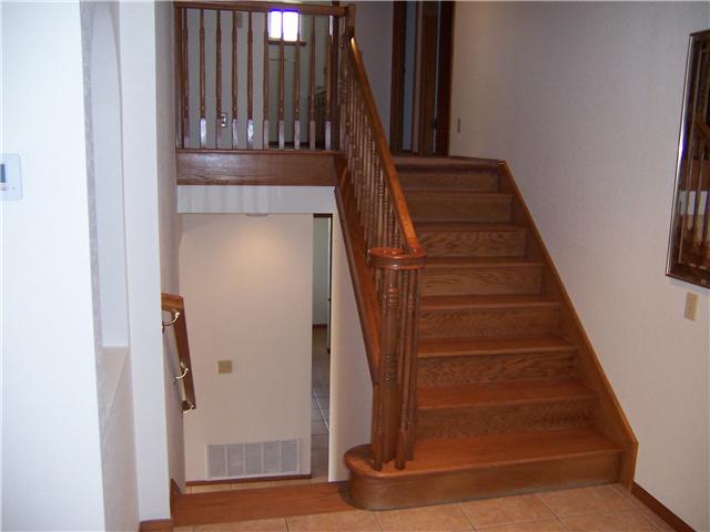 4005 South Mission Road Fallbrook, CA 92028 - Photo 12 of 23 Beautiful solid oak staircase off of entryway leading up to Master and two bedrooms, and down to family room, bedroom and laundry room