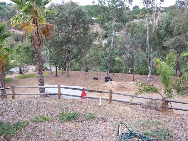 4005 South Mission Road Fallbrook, CA 92028 - Photo 15 of 23 Large level area for horse stables, dog run or parking RV. The mature eucalyptus trees boarder the area to bring shade
