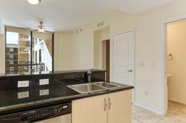 a kitchen with a sink and a refrigerator