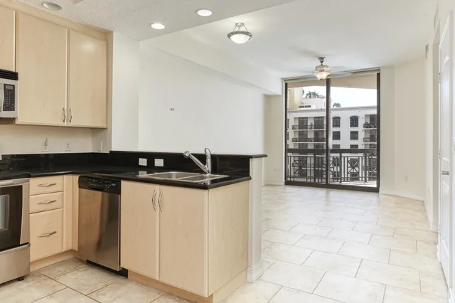 a kitchen with stainless steel appliances granite countertop a stove and a refrigerator