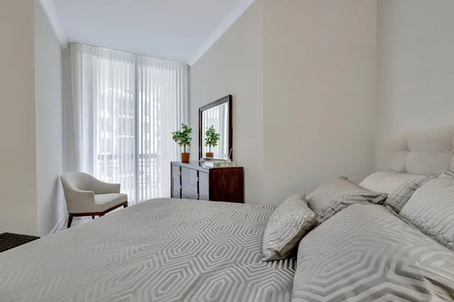 a bedroom with a balcony a bed and a couch