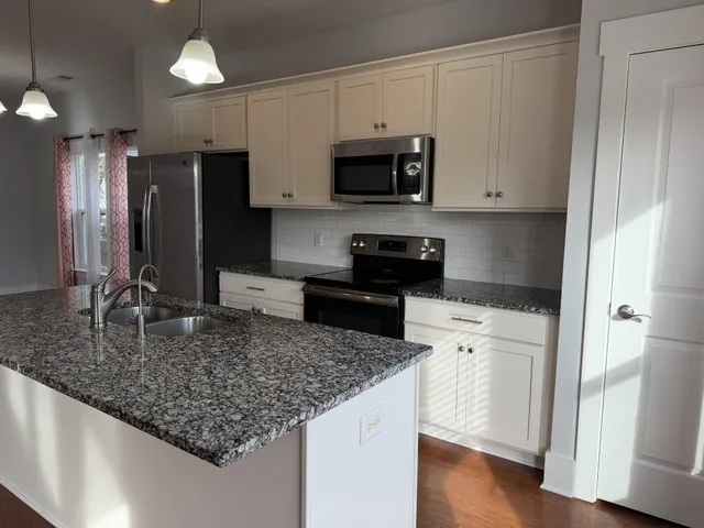 an empty room with a window and a ceiling fan