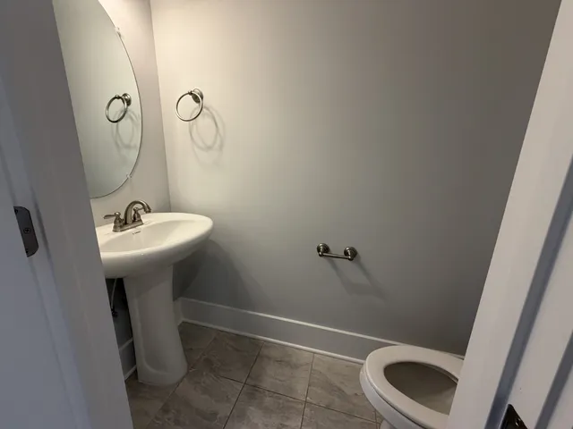 a kitchen with stainless steel appliances granite countertop a refrigerator a sink a stove and a wooden floors