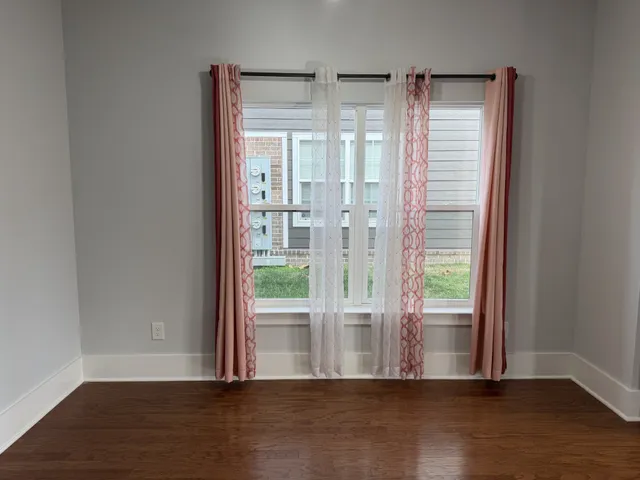 a view of a balcony next to a yard