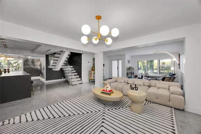 a living room with fireplace furniture and a large window