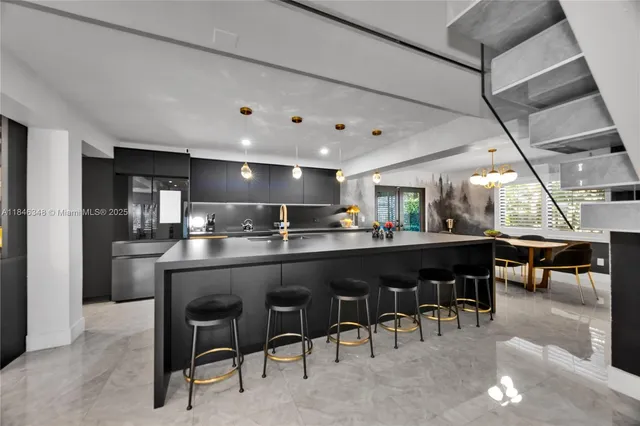 a kitchen with a dining table chairs and refrigerator