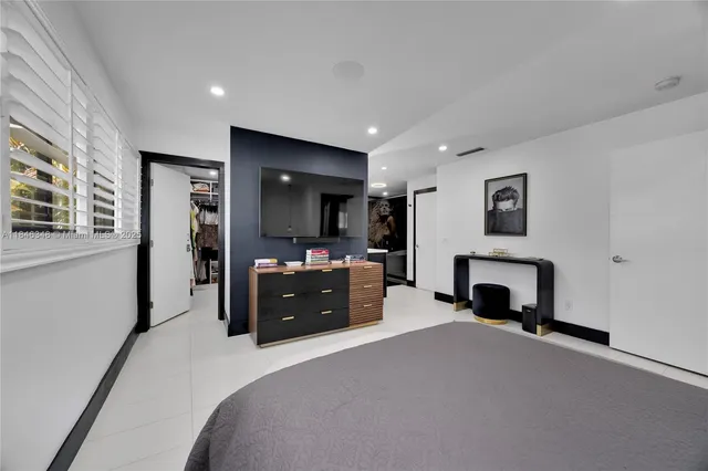 a bed room with a bed and a television