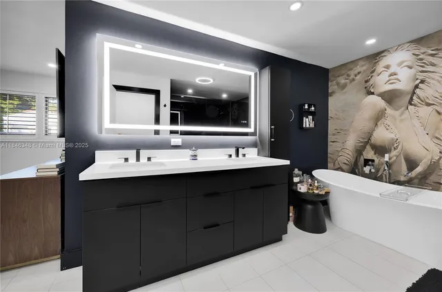 a bathroom with a double vanity sink mirror and bathtub