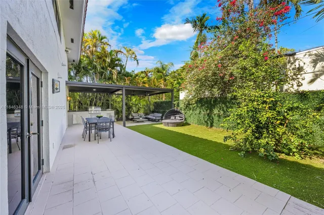 a view of a backyard with sitting area