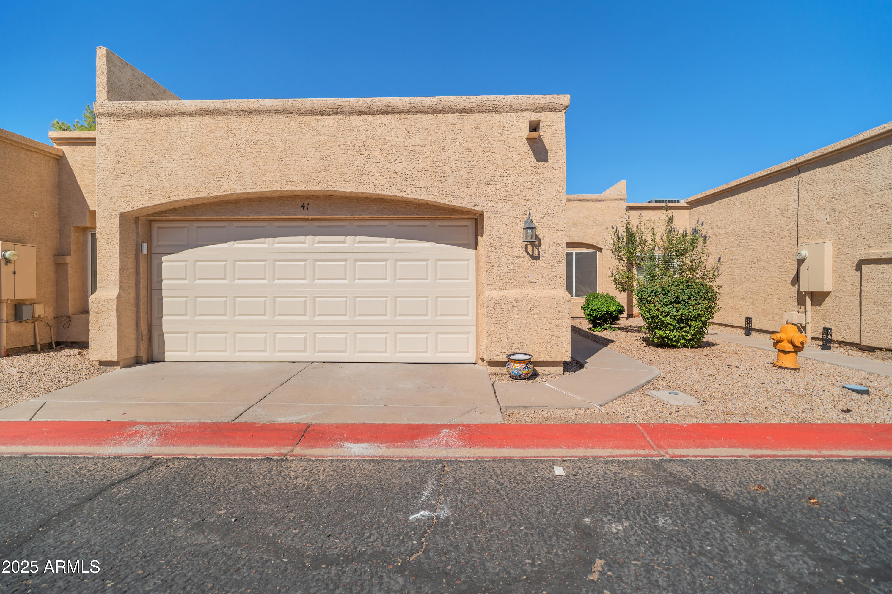625 North Hamilton Street, Unit 41 Chandler, AZ 85225 - Photo 1 of 25 a front view of a house with a yard and garage