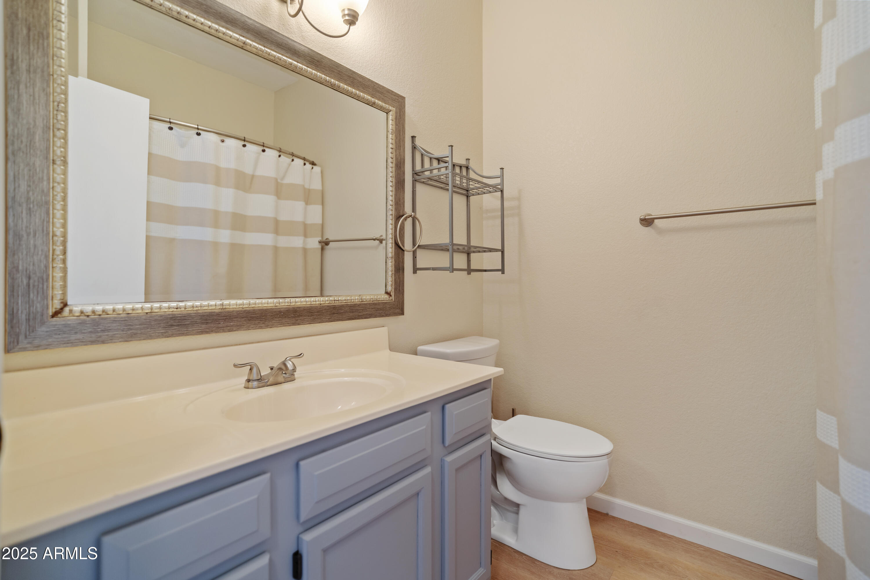 625 North Hamilton Street, Unit 41 Chandler, AZ 85225 - Photo 13 of 25 a bathroom with a sink a toilet and a mirror