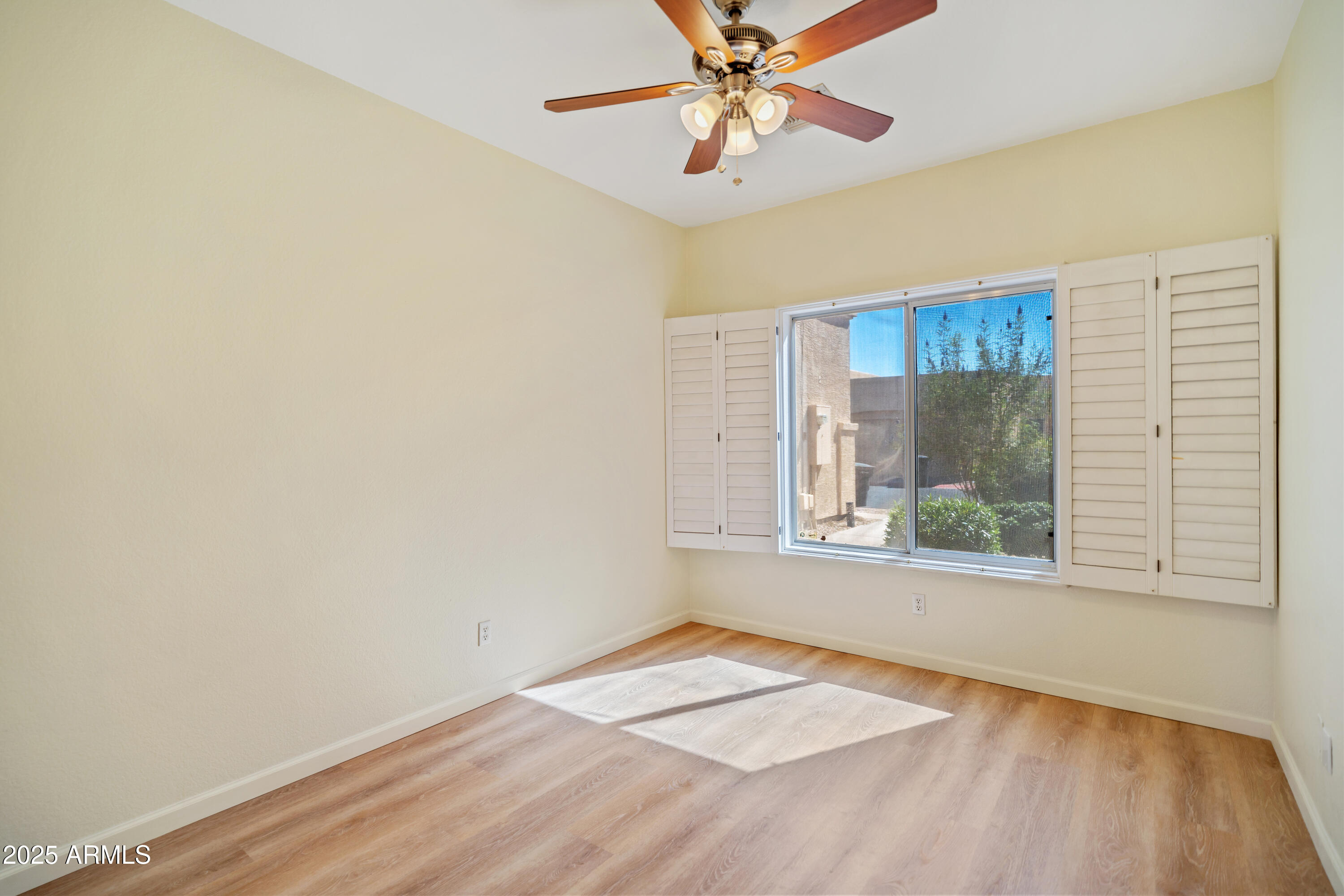 625 North Hamilton Street, Unit 41 Chandler, AZ 85225 - Photo 15 of 25 a view of an empty room with a window and wooden floor