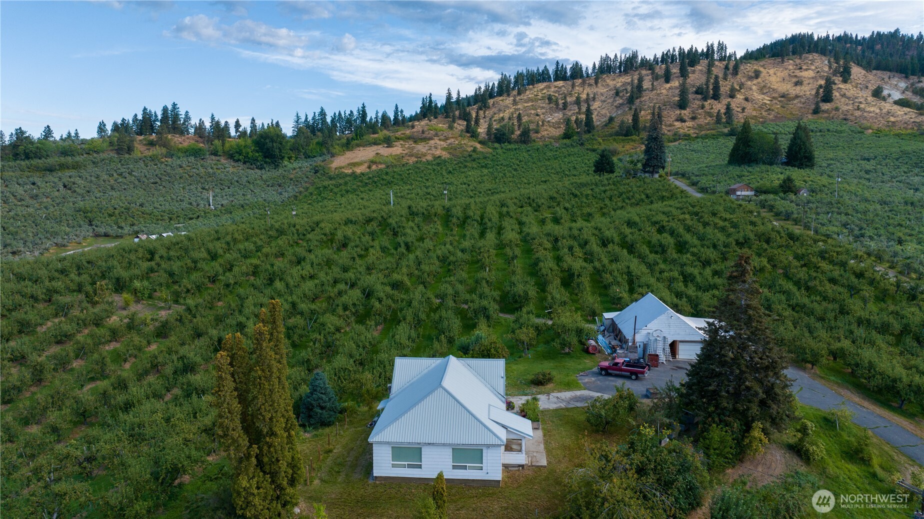 aerial view of a house with yard and green space