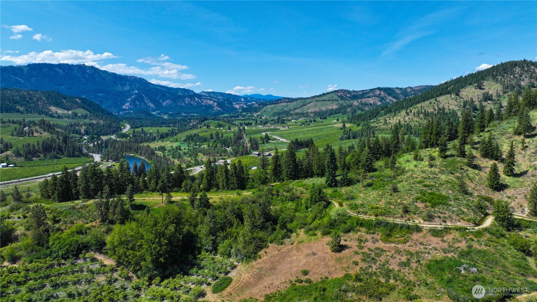8612 Ludwig Hill Road Peshastin, WA 98847 - Photo 29 of 30 a view of a lush green outdoor space with a lake view