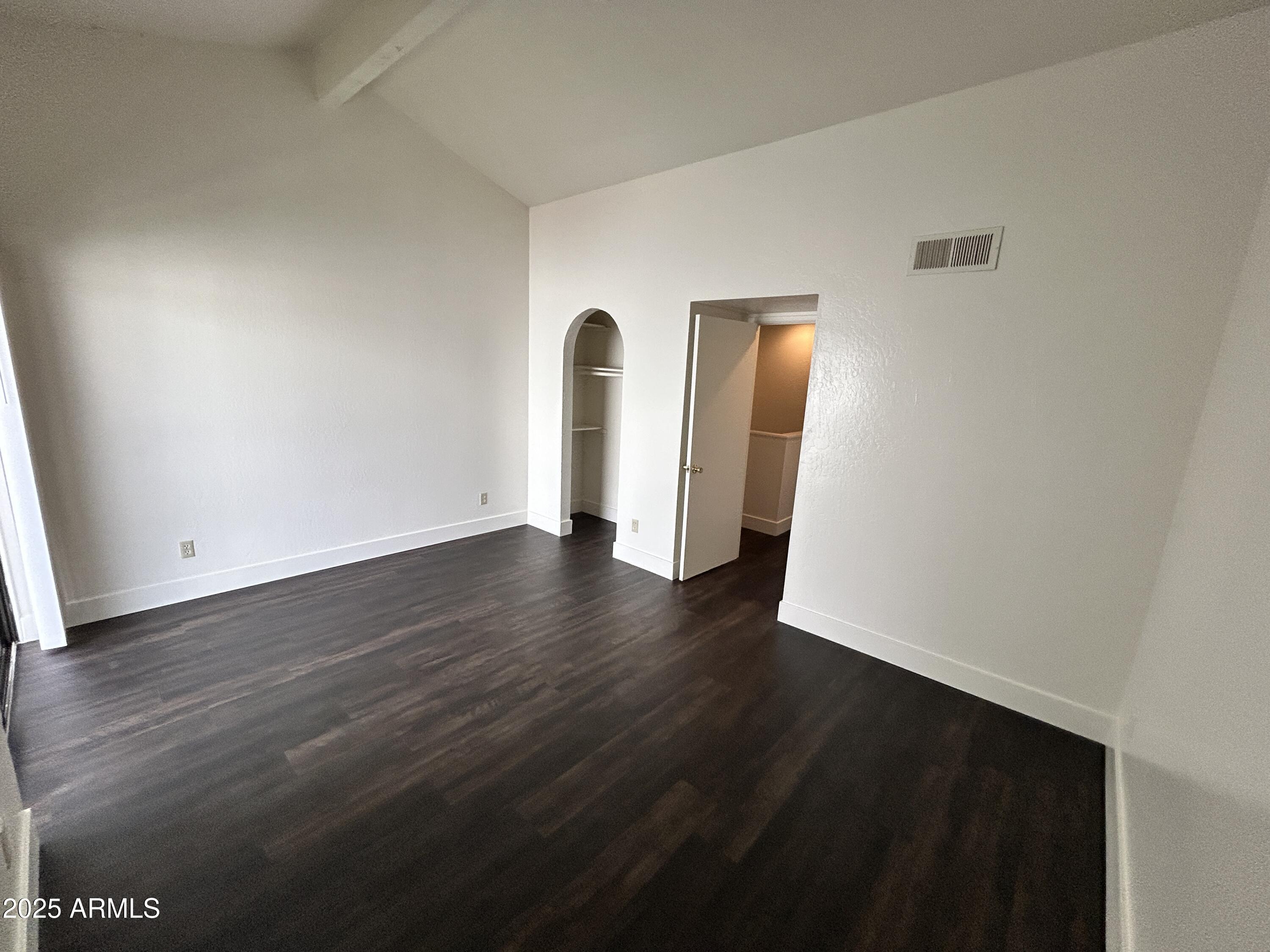 1702 East Ocotillo Road, Unit 2 Phoenix, AZ 85016 - Photo 11 of 18 a view of an empty room with wooden floor and closet