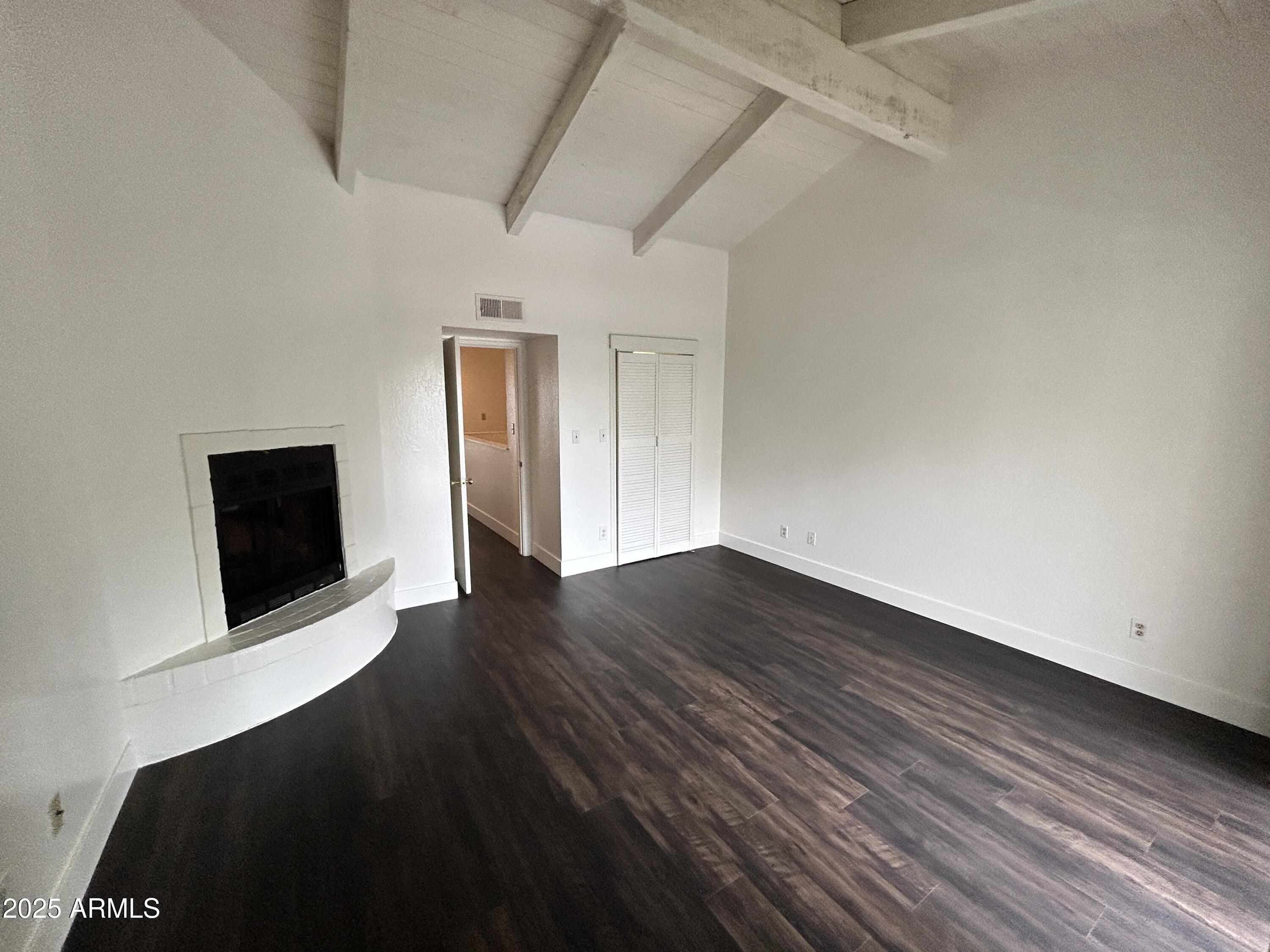 1702 East Ocotillo Road, Unit 2 Phoenix, AZ 85016 - Photo 13 of 18 a view of an empty room with wooden floor and a fireplace