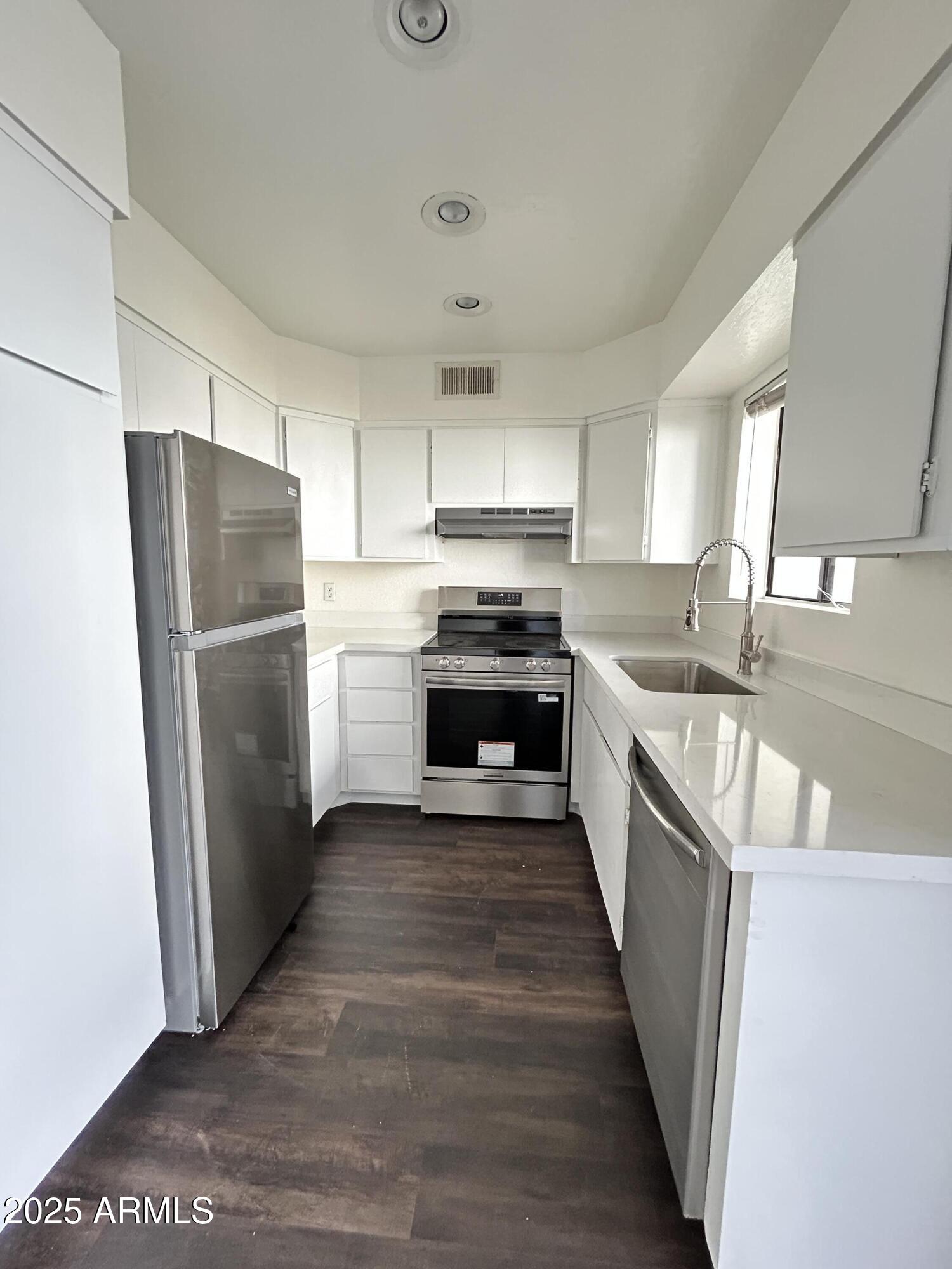 1702 East Ocotillo Road, Unit 2 Phoenix, AZ 85016 - Photo 5 of 18 a kitchen with a refrigerator a sink and a stove