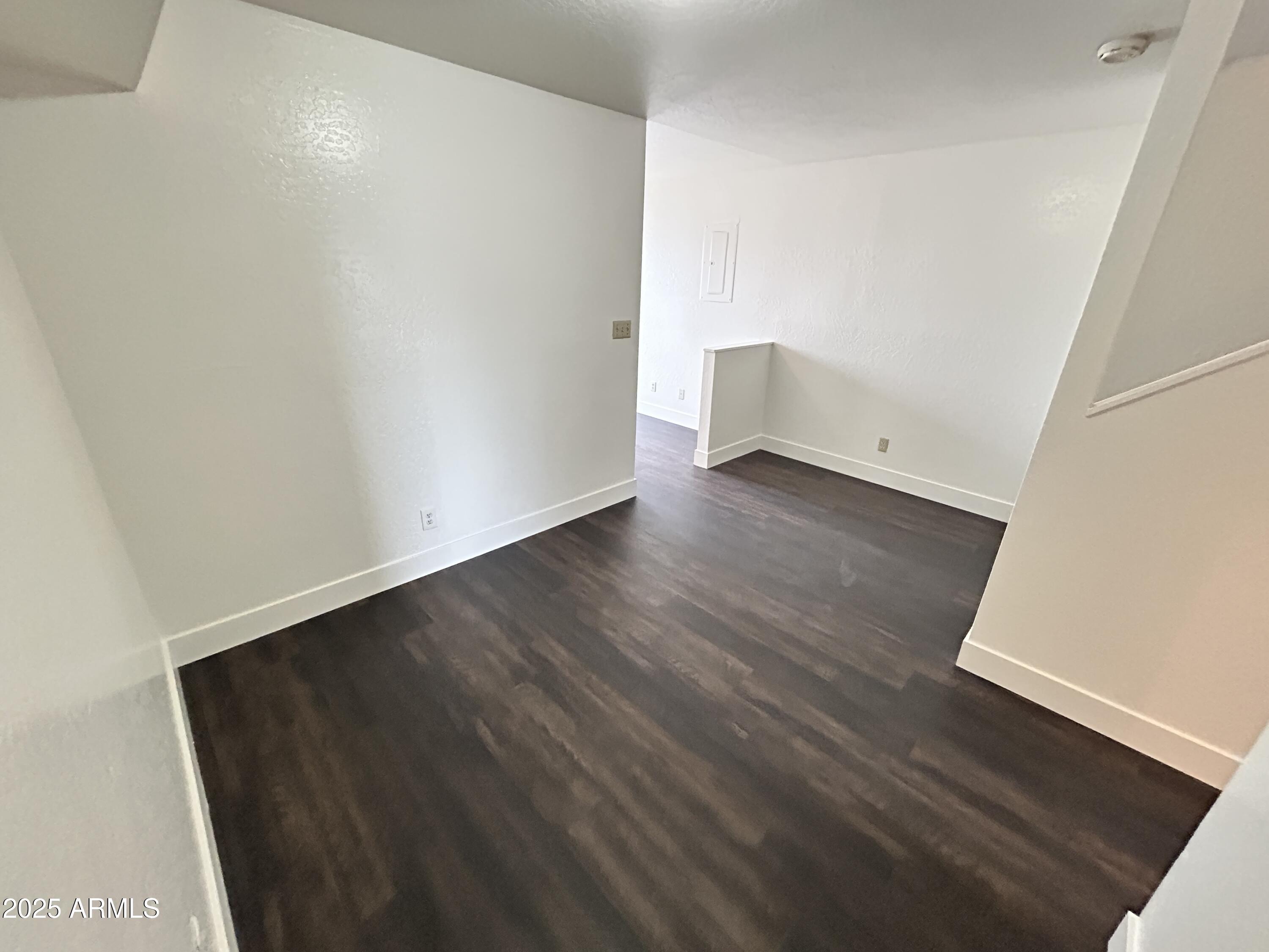 1702 East Ocotillo Road, Unit 2 Phoenix, AZ 85016 - Photo 6 of 18 an empty room with wooden floor