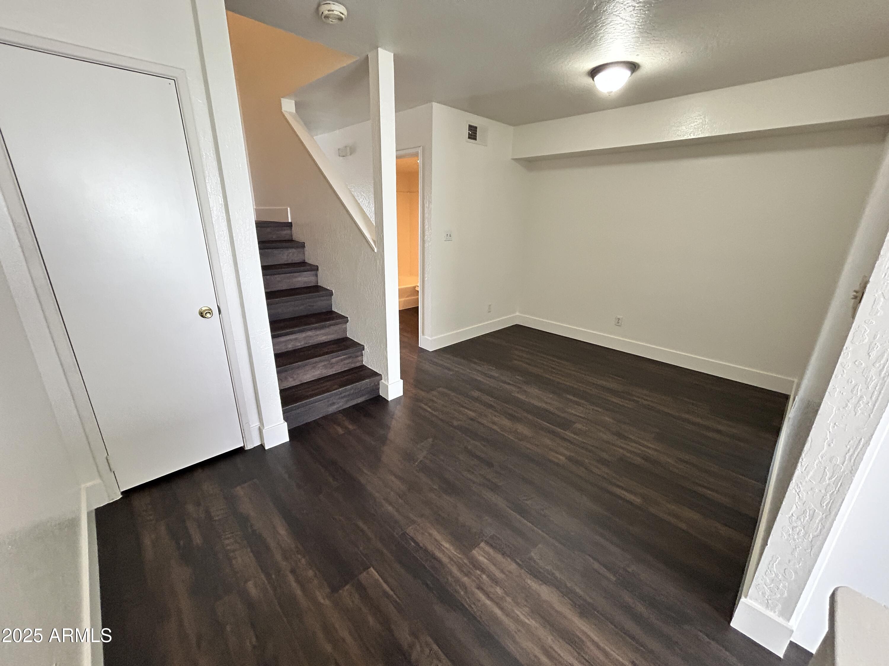 1702 East Ocotillo Road, Unit 2 Phoenix, AZ 85016 - Photo 7 of 18 a view of a hallway with wooden floor and staircase