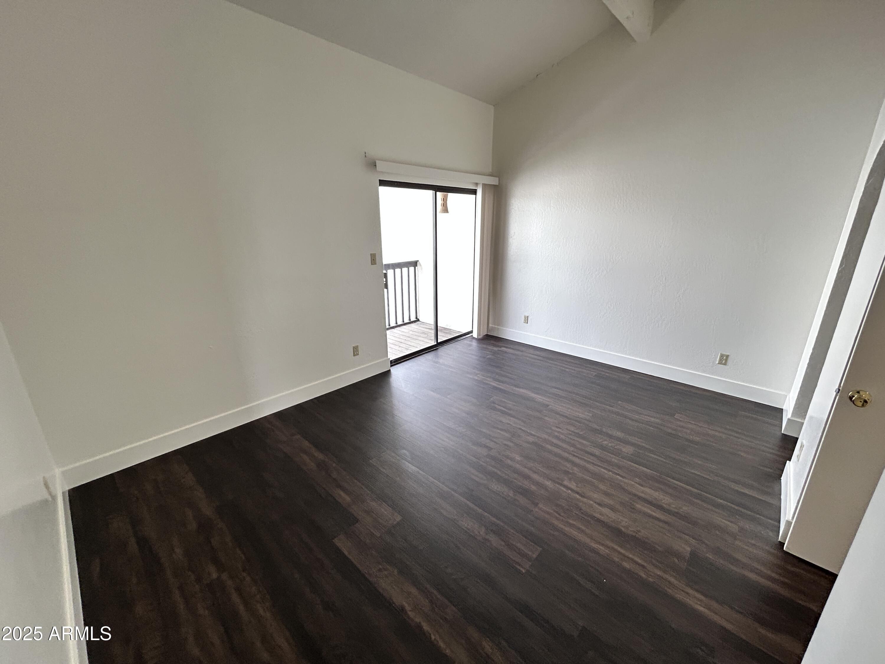 1702 East Ocotillo Road, Unit 2 Phoenix, AZ 85016 - Photo 10 of 18 a view of an empty room with wooden floor and a window